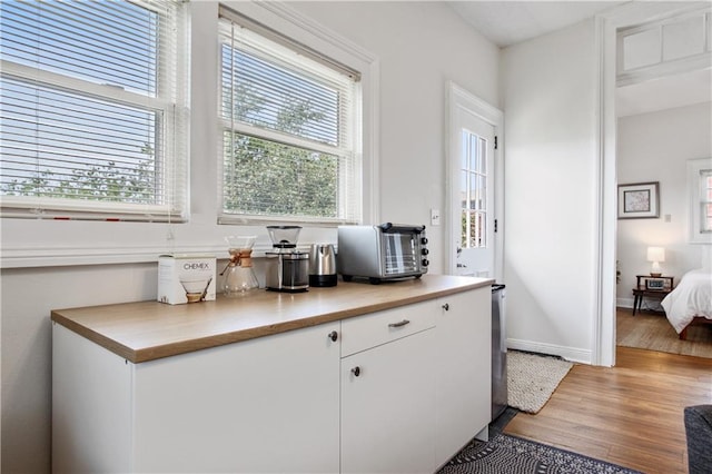 kitchen with white cabinets and hardwood / wood-style floors