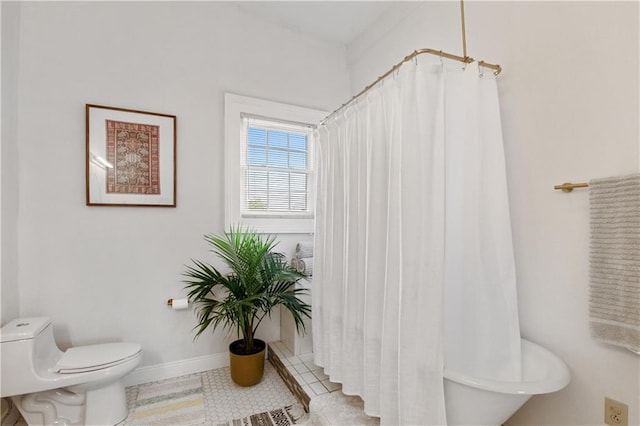 bathroom featuring walk in shower, toilet, and tile patterned floors