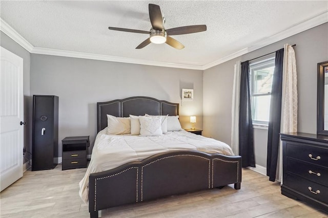 bedroom featuring light wood-type flooring, ceiling fan, a textured ceiling, and crown molding