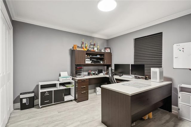 home office featuring light wood-type flooring and ornamental molding