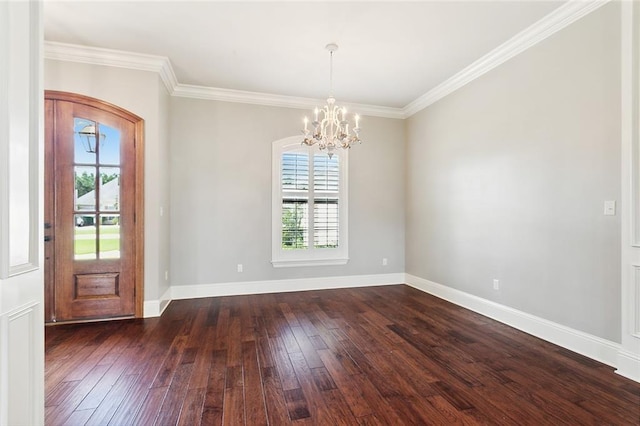 entryway featuring ornamental molding, an inviting chandelier, and dark hardwood / wood-style flooring