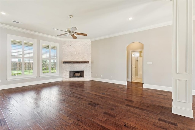 unfurnished living room with ceiling fan, a fireplace, dark hardwood / wood-style floors, and ornamental molding