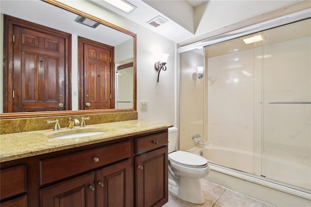 full bathroom with tile patterned flooring, combined bath / shower with glass door, vanity, and toilet