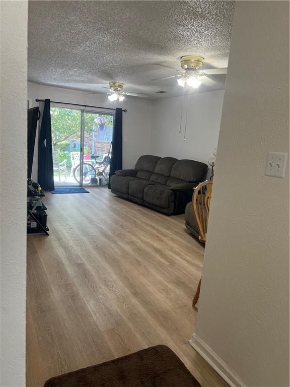 149 Avant Garde Cir Unit 149, Kenner, LA 70065 - living area featuring a textured ceiling, wood finished floors, a ceiling fan, and a textured wall
