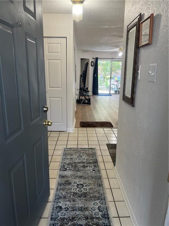 149 Avant Garde Cir Unit 149, Kenner, LA 70065 - corridor with a textured ceiling and light tile patterned floors