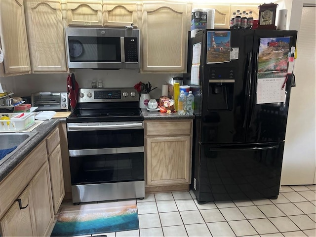 149 Avant Garde Cir Unit 149, Kenner, LA 70065 - kitchen featuring stainless steel appliances, light tile patterned floors, light brown cabinetry, and dark countertops