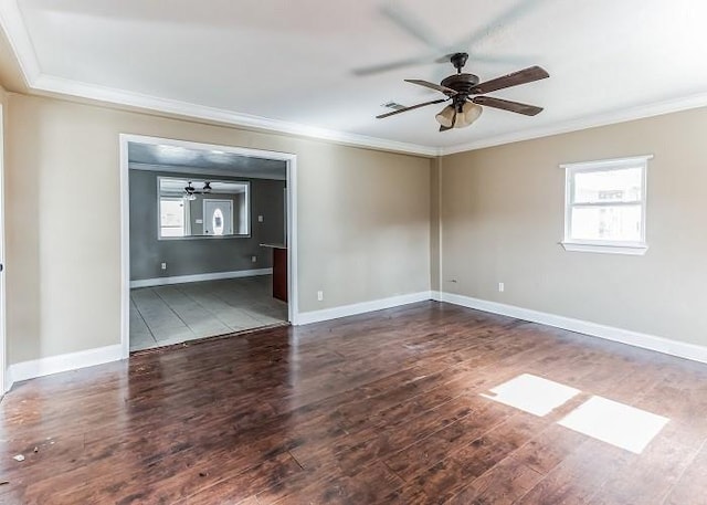 empty room featuring ceiling fan, crown molding, and wood-type flooring