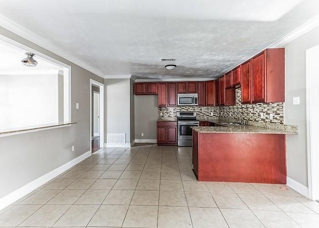 kitchen featuring dark stone counters, kitchen peninsula, stainless steel appliances, backsplash, and crown molding