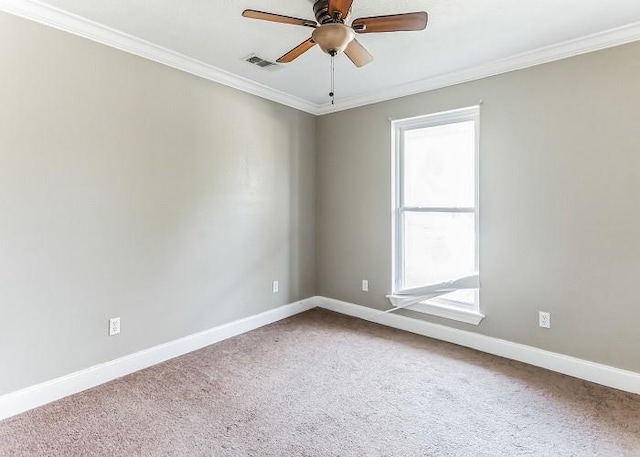 spare room with carpet flooring, ornamental molding, ceiling fan, and a healthy amount of sunlight