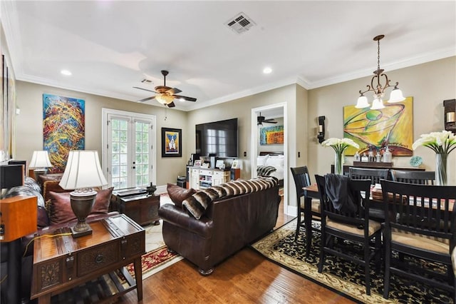 living room with ornamental molding, hardwood / wood-style floors, and ceiling fan