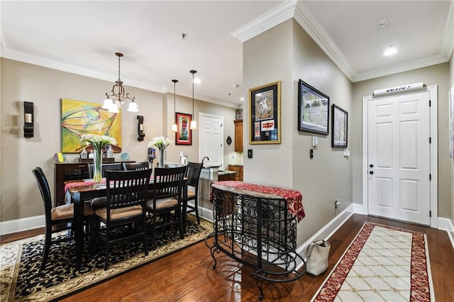 dining area featuring wood-type flooring, crown molding, and a chandelier