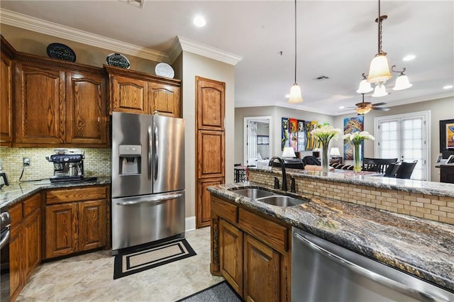 kitchen featuring pendant lighting, stainless steel appliances, ceiling fan, ornamental molding, and sink