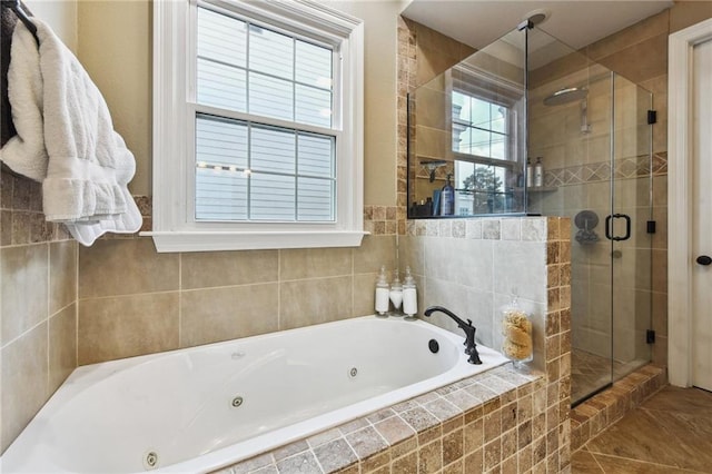 bathroom featuring tile patterned flooring and separate shower and tub