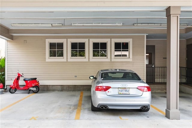 garage with wooden walls and a carport