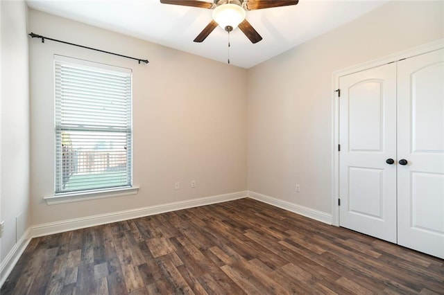 unfurnished room with ceiling fan and dark hardwood / wood-style floors