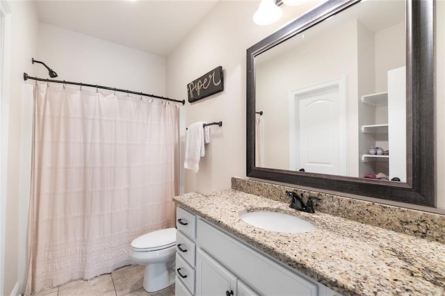 bathroom with tile patterned floors, vanity, toilet, and walk in shower