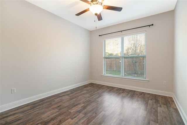 empty room with dark hardwood / wood-style floors and ceiling fan