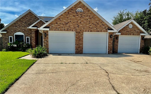 front facade featuring a garage and a front lawn