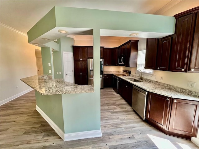 kitchen with light stone counters, light hardwood / wood-style floors, sink, stainless steel appliances, and ornamental molding