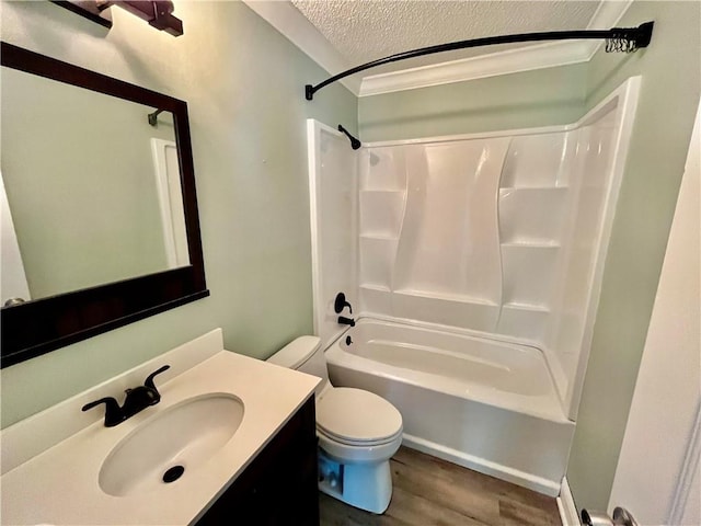 full bathroom featuring shower / washtub combination, vanity, a textured ceiling, hardwood / wood-style flooring, and toilet