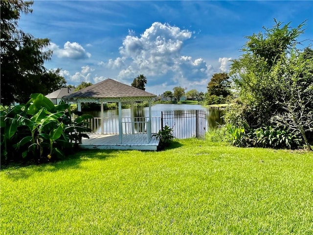 view of yard featuring a gazebo and a deck with water view