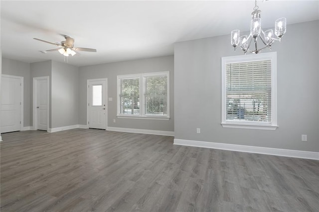 interior space with hardwood / wood-style flooring and ceiling fan with notable chandelier