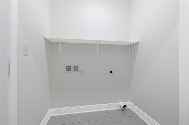 clothes washing area featuring hookup for an electric dryer, washer hookup, and light tile patterned floors