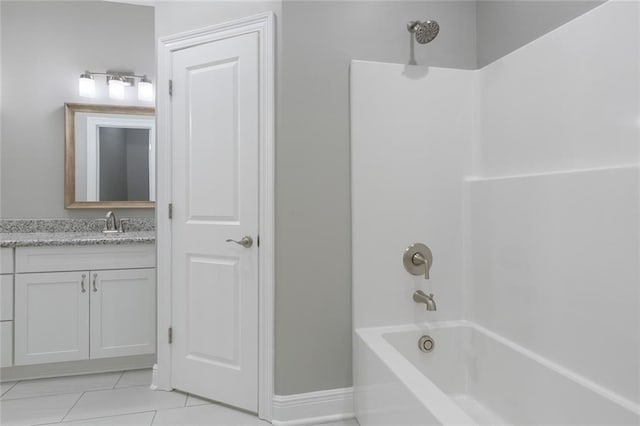 bathroom featuring vanity, washtub / shower combination, and tile patterned flooring