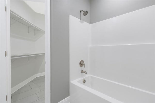 bathroom featuring tile patterned floors and washtub / shower combination