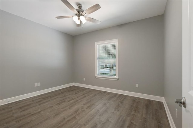 empty room with ceiling fan and dark hardwood / wood-style floors