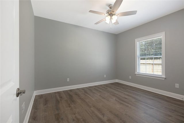 spare room with dark hardwood / wood-style floors and ceiling fan