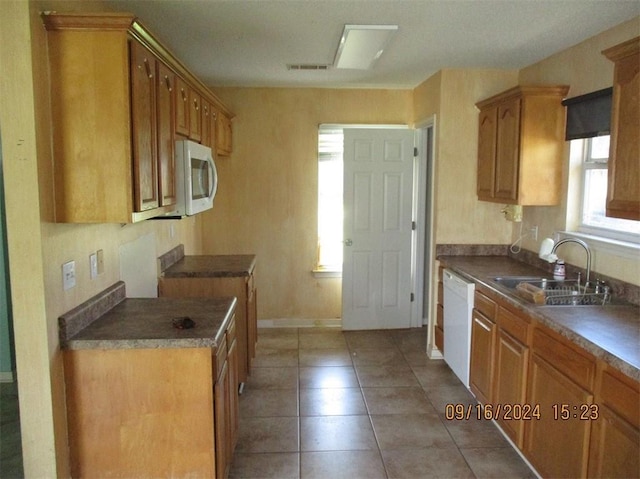 kitchen featuring light tile patterned floors, sink, and white appliances