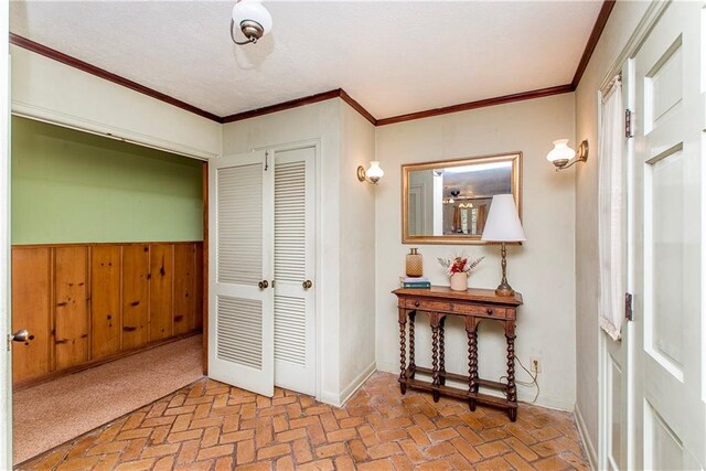 interior space with wood walls and ornamental molding