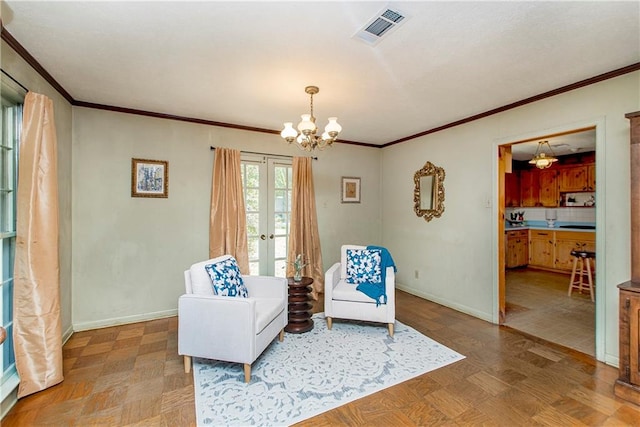 living area with french doors, crown molding, and a chandelier