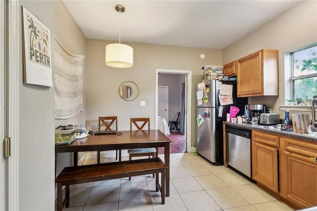 kitchen with pendant lighting, dishwasher, sink, and light tile patterned floors