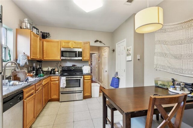 531-33 S Murat St, New Orleans, LA 70119 - kitchen featuring a sink, dark countertops, stainless steel appliances, light tile patterned floors, and visible vents