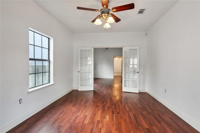 spare room with ceiling fan, dark wood-type flooring, and french doors