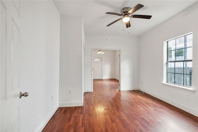 spare room featuring ceiling fan and dark hardwood / wood-style flooring