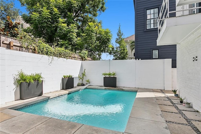 view of swimming pool with a patio area