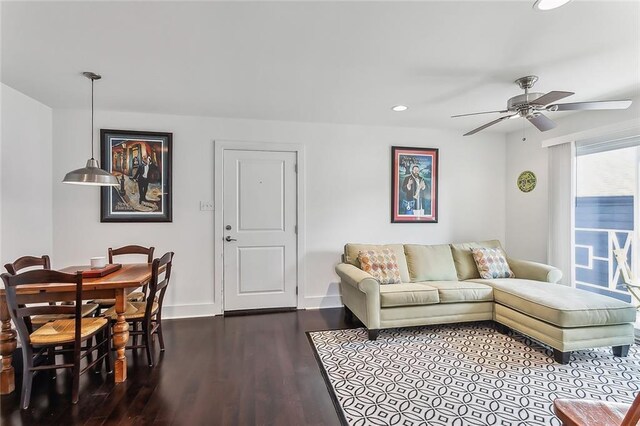 living room with ceiling fan and hardwood / wood-style floors