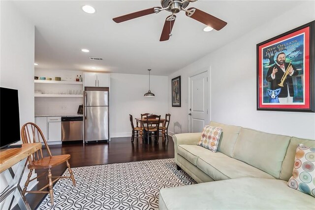 living room featuring ceiling fan and hardwood / wood-style floors