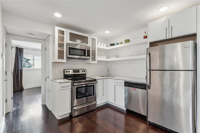 kitchen featuring dark wood-type flooring, white cabinets, appliances with stainless steel finishes, and sink