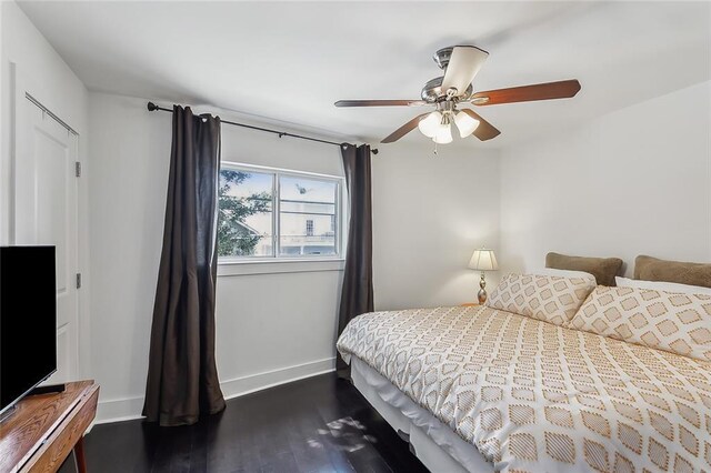 bedroom featuring ceiling fan and dark hardwood / wood-style flooring