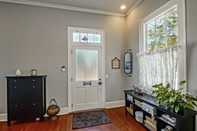 entryway with dark hardwood / wood-style flooring and ornamental molding