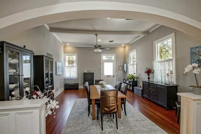 dining area featuring ceiling fan, crown molding, and dark wood-type flooring