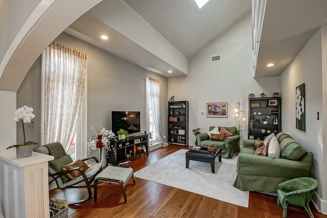 living room featuring hardwood / wood-style floors and lofted ceiling