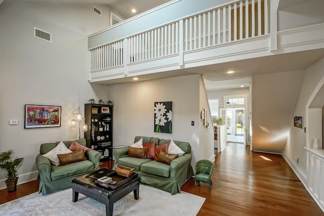 living room featuring hardwood / wood-style floors and a high ceiling