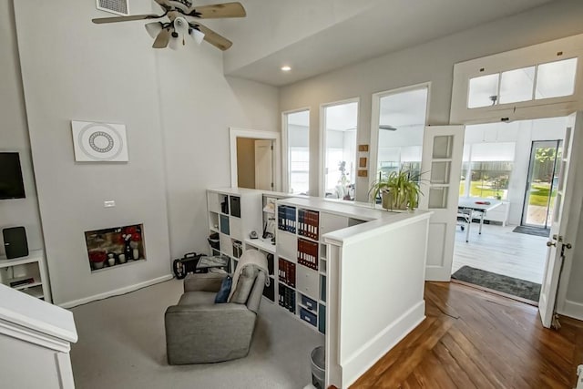 interior space with ceiling fan and dark wood-type flooring