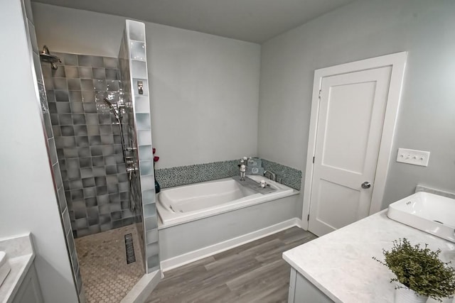 bathroom with hardwood / wood-style floors, vanity, and independent shower and bath