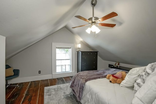 bedroom featuring ceiling fan, dark hardwood / wood-style flooring, and vaulted ceiling